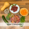 A bowl of raw dog food with beef, courgette, Broccoli, pumpkin, spinach, butternut squash