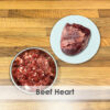 A bowl of raw dog food with beef heart