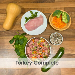 A bowl of raw dog food with turkey, courgette, Broccoli, pumpkin, spinach, butternut squash