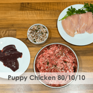 A bowl of raw dog food with chicken, offal, bone, seeds and botanicals