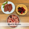 A bowl of raw dog food with beef and summer berries